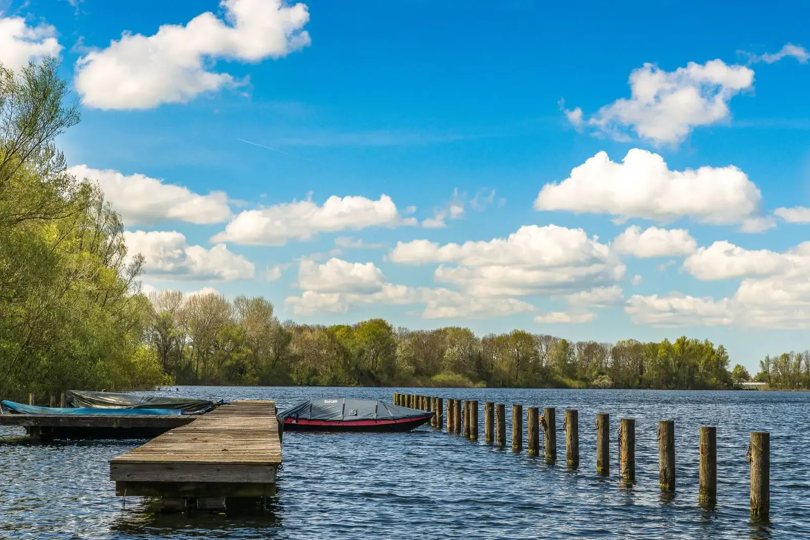 Wooden boat dock and mooring pilings on a Lake of the Ozarks cove in Osage Beach, Missouri